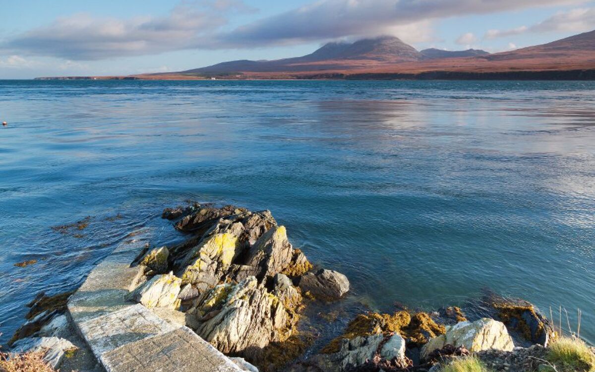 Pier to water's edge, overlooking the mountains of Jura